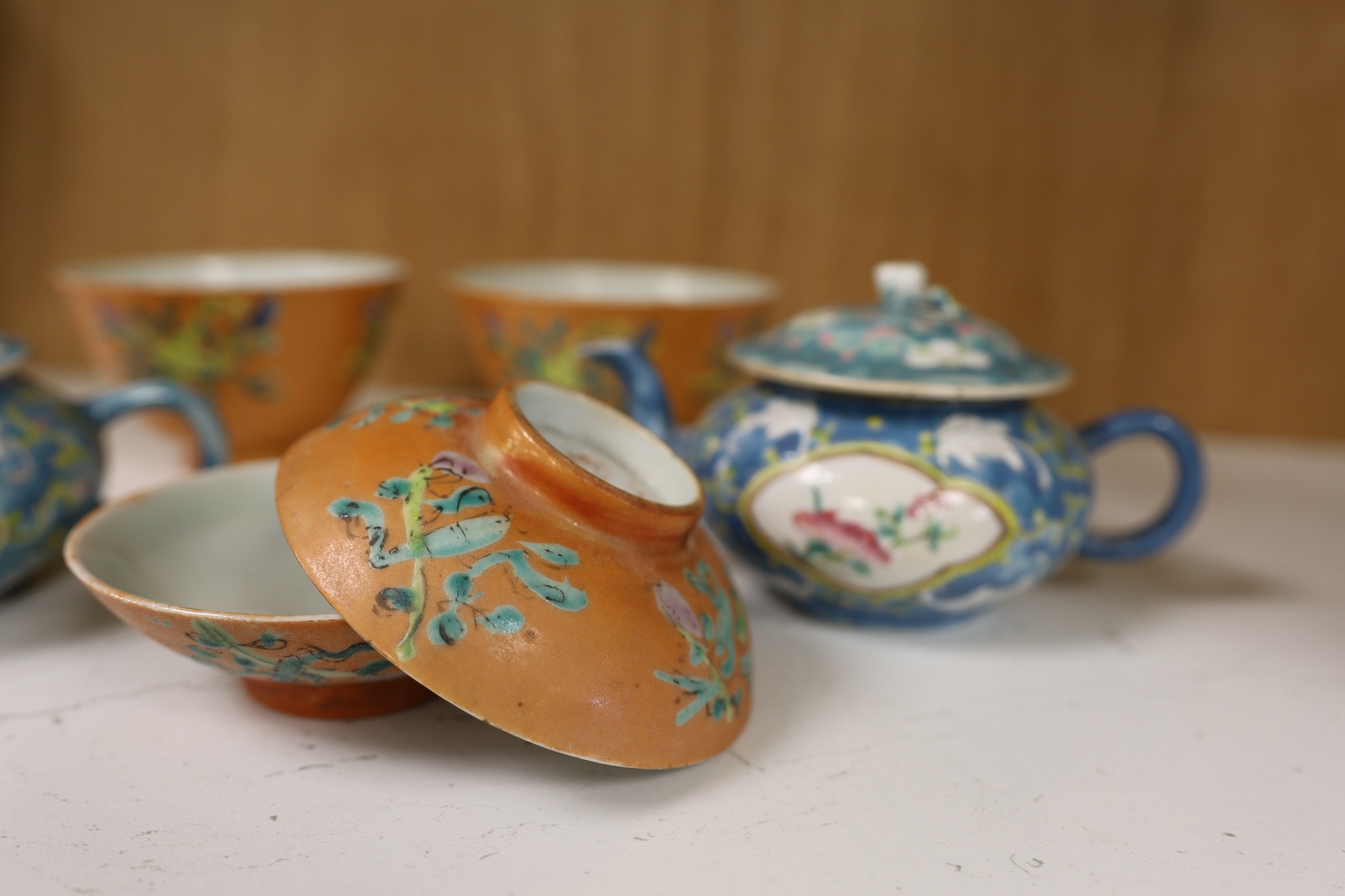 Two Chinese blue ground teapots, Tongzhi mark, and a pair of orange ground bowls and covers, teapots 15cm wide. Condition - fair